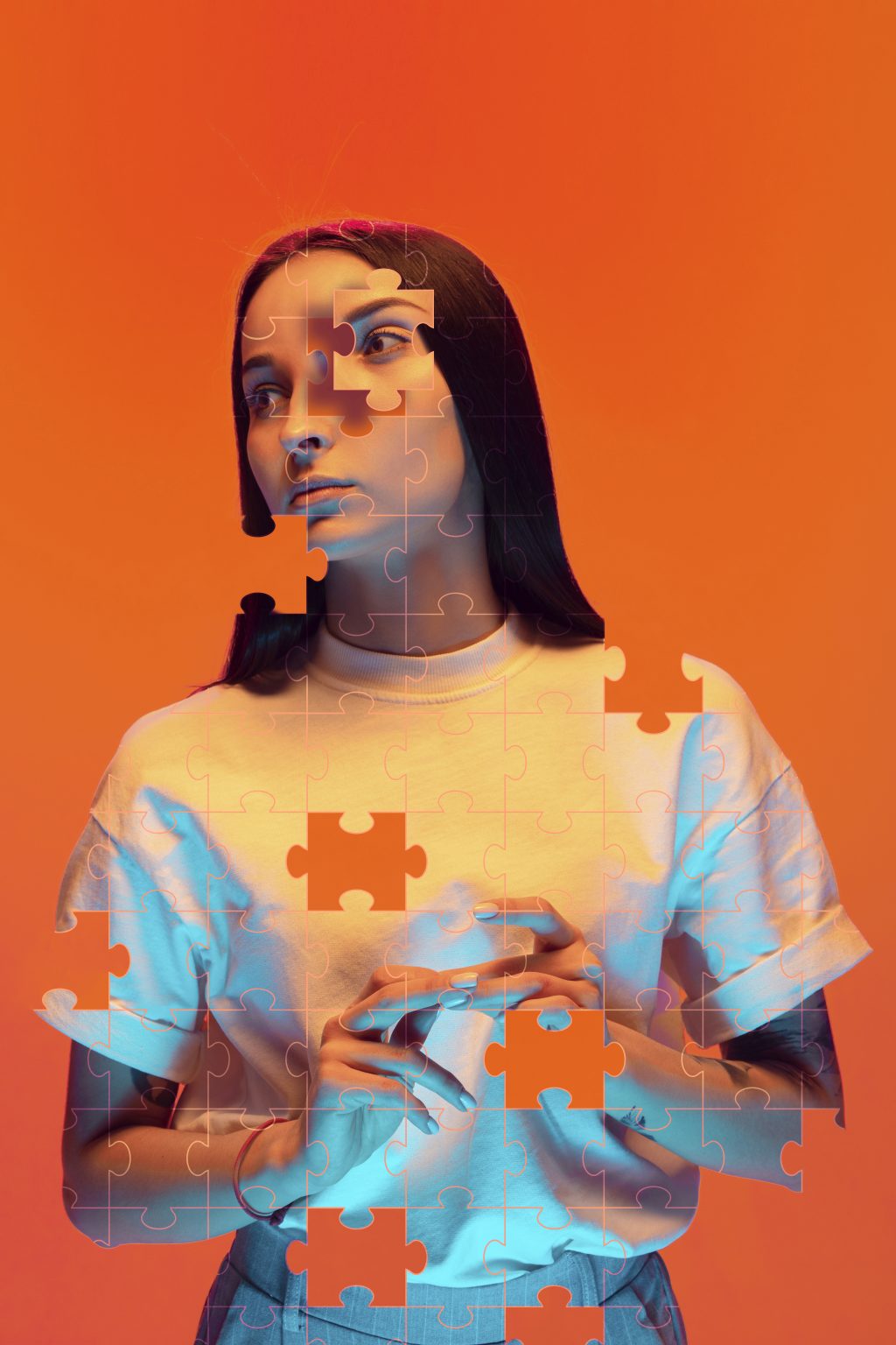 Portrait photograph of someone that has been edited to have jigsaw pieces breaking it up