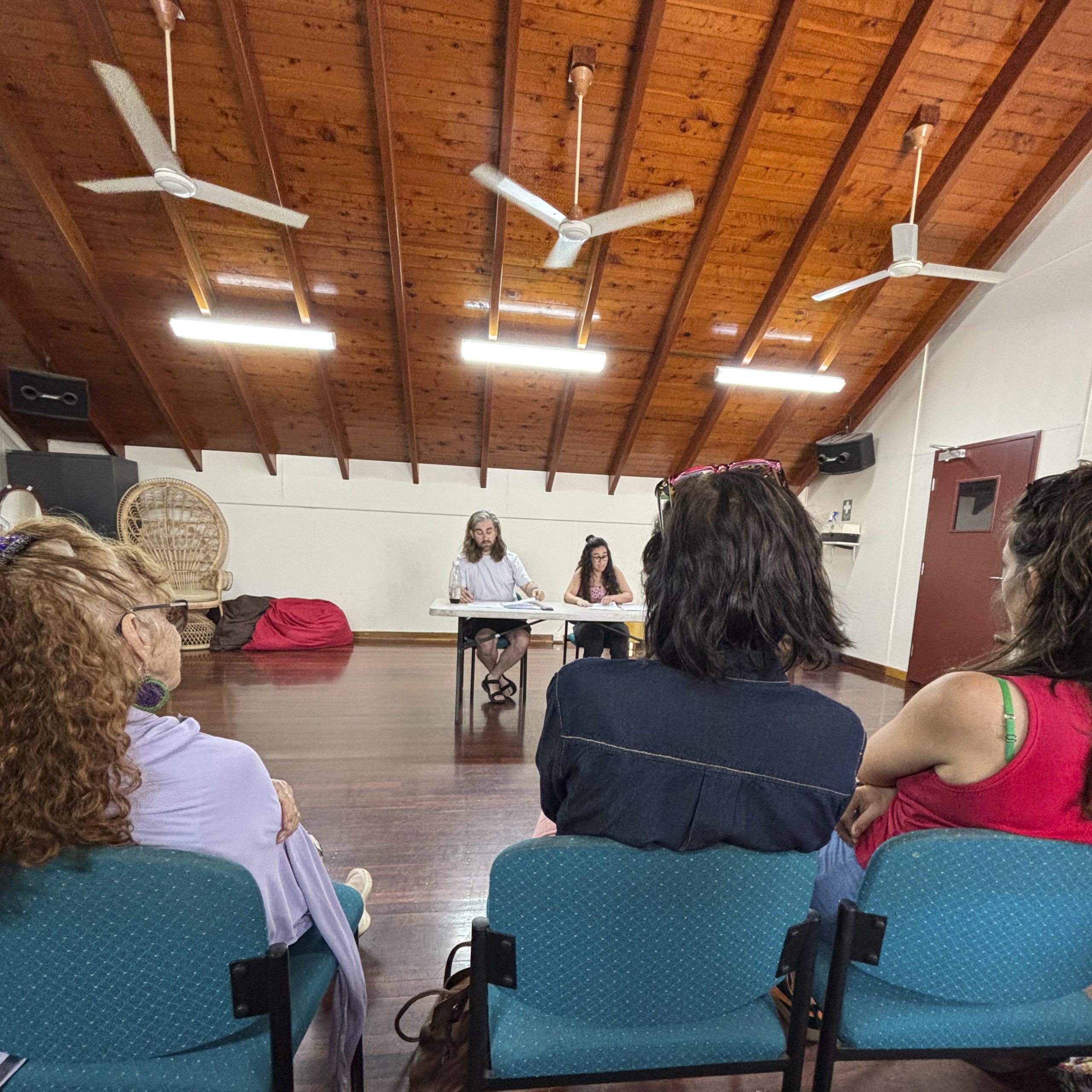 Photograph of people watching 2 people speak in the Brown's Mart Rehearsal room