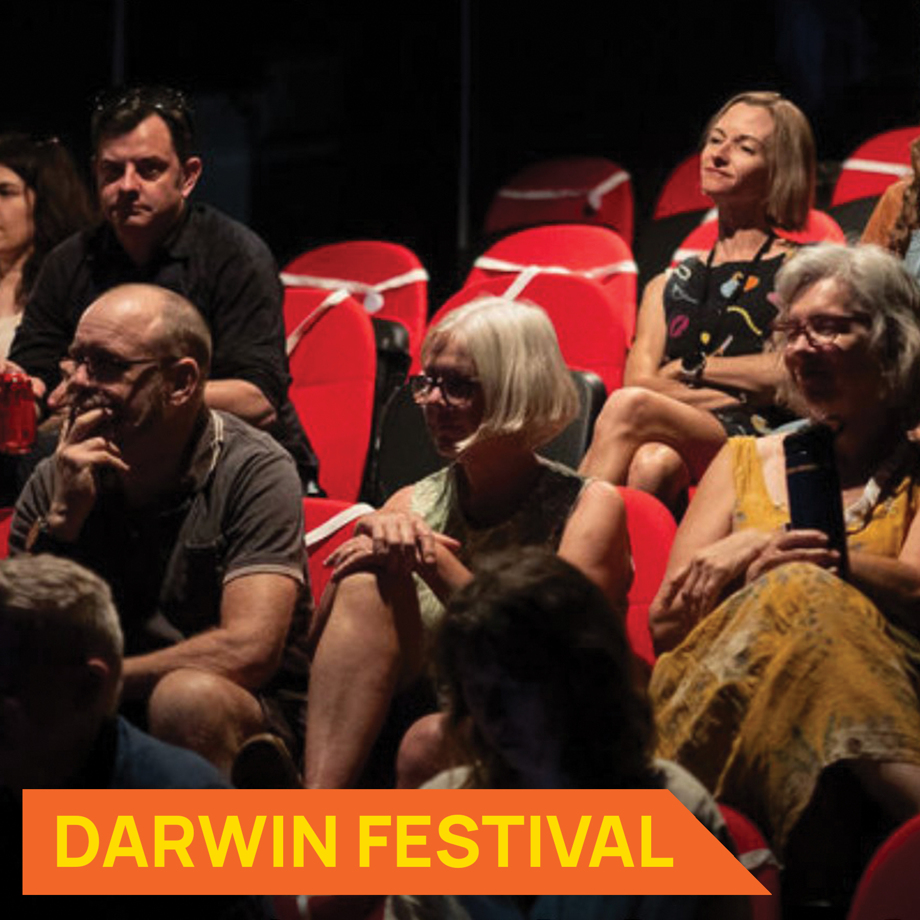 Photograph of people sitting down listening