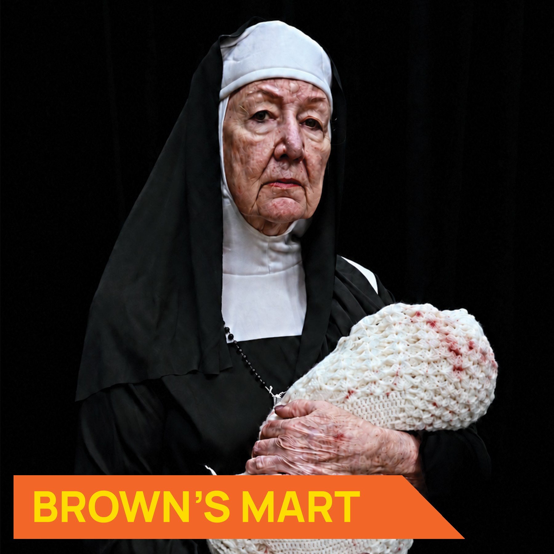 Photograpah of a nun holding a swaddled baby